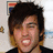 A pixelated image of a person with dark hair and light skin, wearing a black top, next to red background with text.