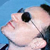 Pixelated close-up of a cartoon character's face with light skin, dark hair, and large black eyes against a blue background.