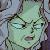 Pixelated static image of a green-skinned face with closed eyes, dark hair, and a blurred background of muted grays and blues.