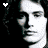 Black-and-white pixelated portrait of a person with long hair, displayed in a with heart symbols above and below the image