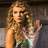 A pixelated image of a woman with curly hair on the left, next to green background text reading "He's the reason for the teardrops on my guitar".