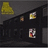 A dark, angled structure with four distinct pixelated icons against a gray background; one yellow triangular icon and three smaller square icons in various colors.