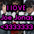 A pixelated image of a group in gray suits with white shirts, holding red flowers, overlaid with pink text reading "I LOVE Joe Jonas <3333333".