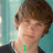 A pixelated image of a person with brown hair and blue eyes, wearing a dark shirt against a light blue background, with cyan text reading "I LOVE TONY OLLER".