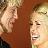 Two pixelated figures face each other against a brown background, one with light hair and the other with dark hair, both with visible facial features and partial clothing details.