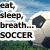 A soccer ball on grass under a blue sky with text reading 'eat, sleep, breath... SOCCER' in the top-left corner.