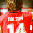 A pixelated image split into two sections: a red sports jersey with white text and numbers on the left, and blue background with dark text and pink heart on the right.