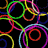 Colorful neon circles in multiple hues overlap and interlock on a black background, with no visible text or distinct figures.