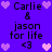 Purple background with repeated text and heart symbols in black and pink pixels.