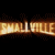 Animated contact sheet showing two frames of a Smallville-themed buddy icon with fiery text and character portraits against black background.