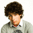 Pixelated image of a person with curly brown hair wearing a light gray sweater over a white collared shirt, next to pink pixelated text on a black background.