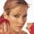 Pixelated static image of a person with light brown hair tied back, wearing red clothing and visible shoulder straps, against a white background.
