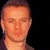 Pixelated static image of a person's face with orange-toned skin and dark hair against a black background, appearing as an AOL Instant Messenger buddy icon.