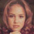 Pixelated portrait of a person with light brown hair and closed eyes against a dark background