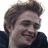 A static image shows a person with light brown hair in two side-by-side , one with a white background and the other with a green background, with text below reading "HELLO MY NAME IS Edward Cullen's girlfriend"