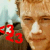 A pixelated close-up of a person's face with red numerals '23' overlaid on the left side, set against a blurred background.