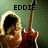 A person with light brown hair holds a red electric guitar against a green background, with text labels above the head in each
