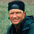 A pixelated image shows a person in dark clothing and cap on the left, with a white background featuring brown text reading 'Timothy Treadwell' and a bear outline on the right.