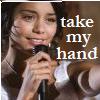 A person holding a microphone with text 'take my hand' overlaid on the right side of the image.
