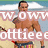 A shirtless man with a tattoo on his left shoulder holds a surfboard at the beach, wearing colorful striped swim trunks.