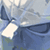 Pixelated static image of a blue and white abstract shape with light gray background, likely representing an anime-style character or object from Disgaea series.