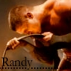 A person with short brown hair plays a cello, wearing a light-colored shirt against a warm-toned background with the name 'Randy' in dark text.