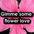 Pixelated pink background with black floral shapes and two lines of white text on black bars.