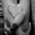 A grayscale pixelated image of a heart shape formed by light gray lines on a darker background with visible digital noise.
