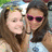 Two women pose together in a pixelated image with one wearing pink sunglasses and the other smiling, set against an outdoor background.
