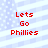 Red text 'Lets Go Phillies' on a light blue and white striped background with pixelated dots.