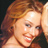 Static 48x48 pixel icon showing a close-up of a person with long wavy red hair, visible facial features including eyes and mouth, and light skin tone against dark background.