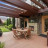 Pixelated static image of a house with a brown roof, greenery, and a light-colored pathway under a bright sky.