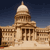 Pixelated image of a classical building with columns and a dome under a dark blue sky.