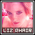 Pixelated image of a person with light skin tone and pink-toned hair, wearing pink eyeshadow and red lips, with text "L12 PHAIR" at the bottom.