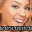 Static pixelated image of a smiling person with visible eyes, nose, mouth, and hair, featuring text at the bottom in blocky gray letters on black background.