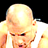 Static pixelated image of a bald character with light skin wearing a white shirt, set against black background.