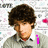 A person with curly brown hair wears a light gray collared shirt against a white background with faint text and red heart shapes, showing three distinct states of visible text.
