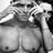 Static grayscale image of a person in a 3D-rendered pose with visible chest and shoulder details, cropped to show upper body against a pixelated background.