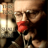 showing a person with glasses holding a red rose to their mouth, text reads "THIS TOO SHALL FADE" on the left side