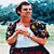 A pixelated image of a person in a white tank top and patterned jacket holding hands, with text overlays on red and gray backgrounds.