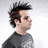 Pixelated side profile of a person with dark spiky hair wearing a gray shirt against a light background, next to blue pixelated text reading "Johnny Christ !!!!" on black.