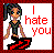 Pixel art of a doll-like figure with multicolored hair in a ponytail, standing on a black platform with red zigzag lines, next to red text reading "I hate you" on a white background with a red border.