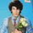 A pixelated image of a person in formal attire holding flowers with text reading "the cute sensitive one" and a pink heart symbol.