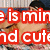 A shirtless person with dark hair lies on a patterned surface, making hand gestures near their face in