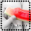 A hand holds a watermelon slice with red flesh and green rind, framed by a black-and-white dotted border with 'taste' text below.
