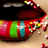 A pixelated red and black object with green, blue, yellow, pink, white, and brown accents on a light beige background.