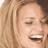 Static 48x48 pixel icon showing a close-up of a person's face with light brown hair and closed eyes, mouth open in laughter or speech, visible teeth, and a small white dot on the cheek.