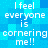 Blue pixelated background with repeated white text reading "I feel everyone is cornering me!!" in a pattern