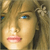 Pixelated close-up of a person's face with light brown hair, blue eyes, and pink lips, rendered in a low-resolution style.