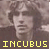 Pixelated static image of a person's face with yellow text "INCUBUS" at the bottom, set against a brownish background.